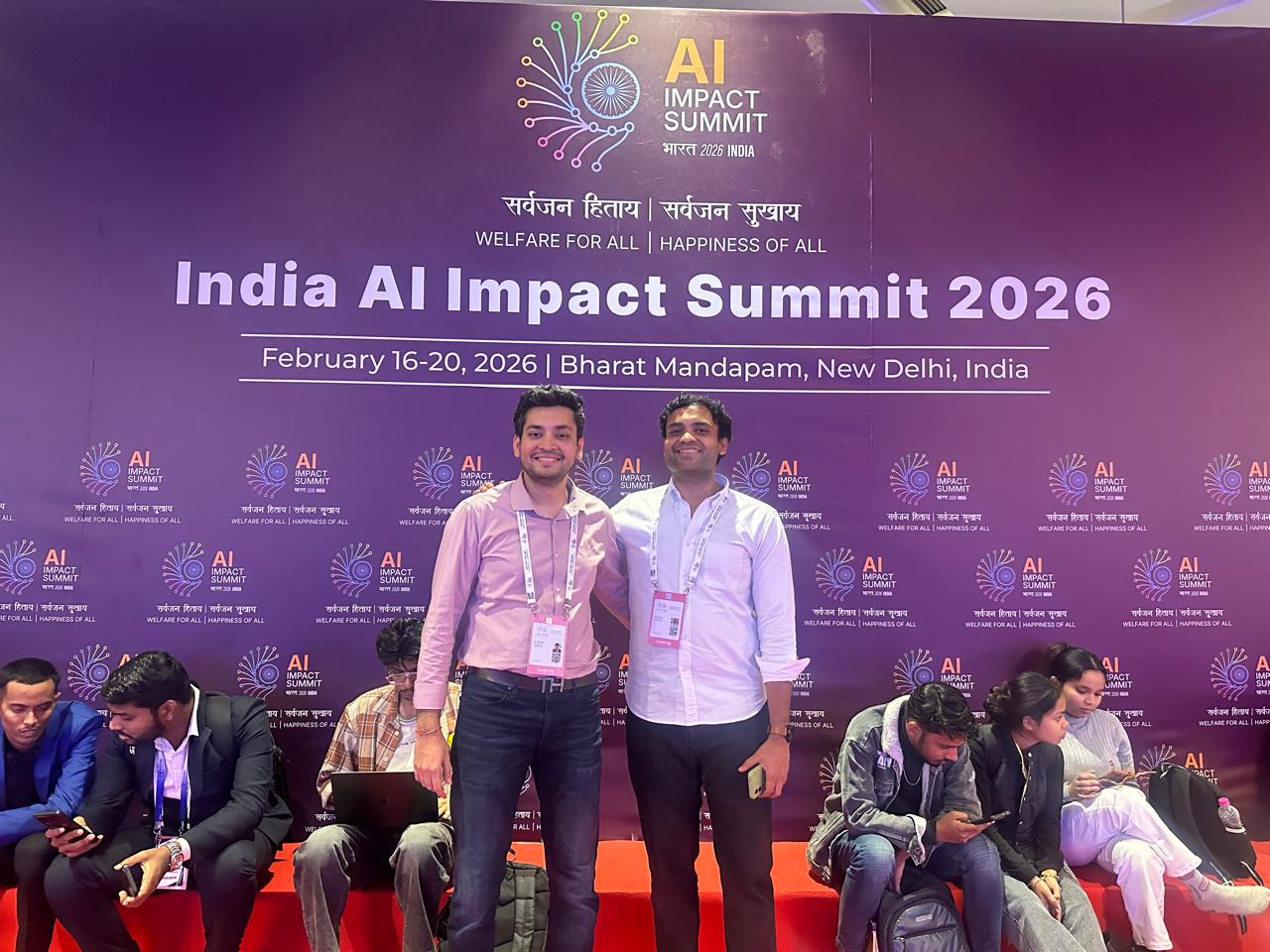 The team at the India AI Impact Summit 2026 backdrop